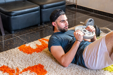 Wall Mural - Guy doing some training at home to keep in good shape