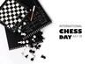 The world day of chess. International chess day. July 20. Holiday greeting poster. Small chess pieces and a chessboard are scattered on the table. White isolated background. Text. Copy space
