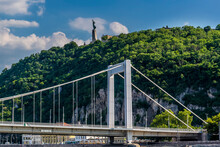 The Elizabeth Bridge Reaches The Western Shore Of The River Danube Below The Liberty Statue In Budapest In The Summertime