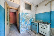 Old Ugly Abandoned Empty Kitchen In A Residential Building. The Interior Of The Collapsing Room Of The Kitchen In The House