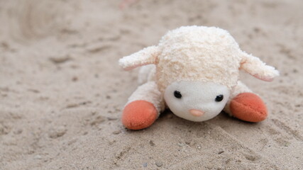 toy sheep on the beach