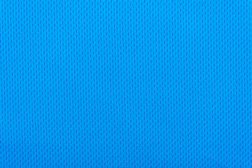 Smooth surface of a blue polyester sport t-shirt as background or texture