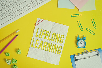 Word writing text Lifelong Learning. Business photo showcasing pursuit of knowledge for an individualal or professional reasons Flat lay above copy space on the white crumpled paper