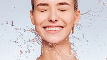 Photo Of  Young  Woman With Clean Skin And Splash Of Water. Portrait Of Smiling Woman With Drops Of Water Around Her Face. Spa Treatment. Girl Washing Her Body With Water. Water And Body.