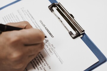 Canvas Print - Closeup shot of a person filling in a legal document