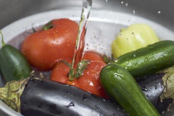 Poster - Closeup shot of vegetables being rinsed under the running water