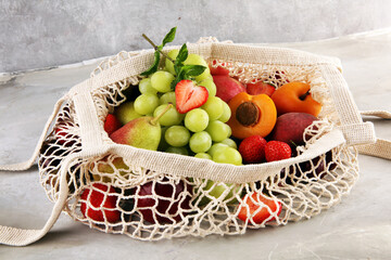 Wall Mural - Fresh summer fruits in eco bag with apple, grapes, berries, plums and healthy apricot.