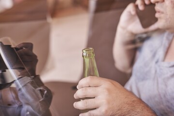 Poster - Man talking on the phone holding a bottle of beer in his hands