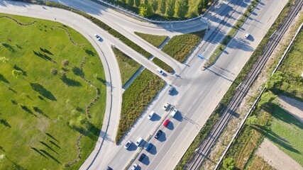 Aerial view of two lane bridge driveway. There is an inner ring road at the bottom.  Vehicles and commercial vehicles can also be seen. 
