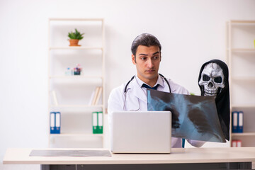 Wall Mural - Male devil doctor radiologist working in the clinic