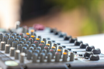 Close-up of the sound mixer used in the recording room with selective focus.