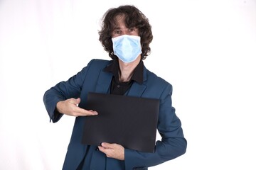 Canvas Print - Male in a face mask showing a blank black surface with space for text