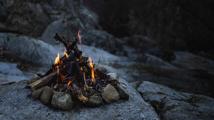 Canvas Print - Small bonfire with beautiful flames on the rocks