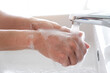 © Photo Sesaon - Hands of woman wash their hands in a sink with foam to wash the skin and water flows through the hands. Concept of health, cleaning and preventing germs and coronavirus from contacting hands