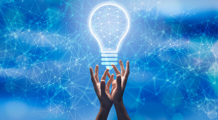 Poster - Innovative Ideas. Male hands holding glowing polygonal light bulb on abstract background