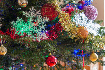 The Christmas tree with bright toys and garlands.