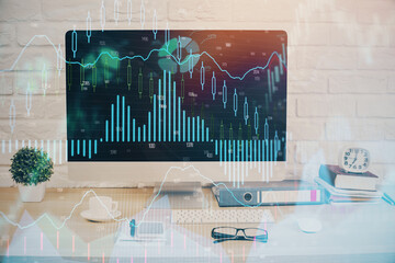 Forex graph hologram on table with computer background. Double exposure. Concept of financial markets.