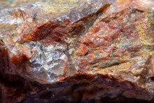 Photograph Of A Granite Surface Interspersed With Transparent Mica In Soft Focus At High Magnification. Fine Texture Of Natural Mineral Of Pink Color With Blurred Background.