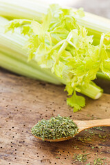 Sticker - Green fresh celery together with dry celery seasoning in spoon