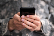 Social Cyber Warfare. Army Soldier Using Phone