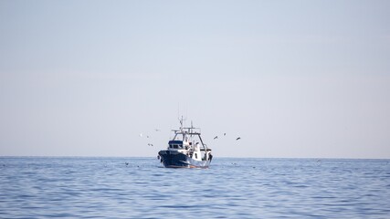 Sticker - Landscape shot of a fishing trawler on a sunny day