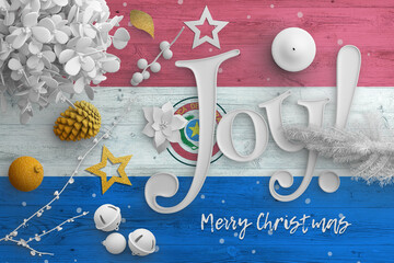Paraguay flag on wooden table with joy text. Christmas and new year background, celebration national concept with white decor.