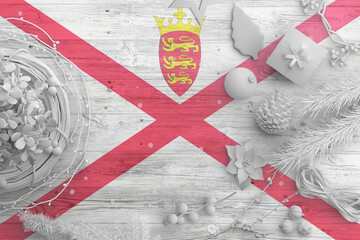 Wall Mural - Jersey flag on wooden table with snow objects. Christmas and new year background, celebration national concept with white decor.