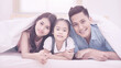 © ChomchoeiFoto - Asian family happy smiling and relax on bed at home. Photo series of family, kids and happy people concept.