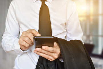 Canvas Print - closeup of businessman hand using mobile phone. idea for business, technology and online marketing.