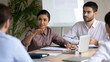 © fizkes - Indian businesswoman speaking, sharing ideas with diverse colleagues at corporate meeting, business partners discussing strategy, project statistics or financial report, sitting at table in boardroom