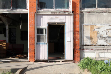 Wall Mural - an abandoned deserted old store shop that has been vandalized and damaged then left derelict