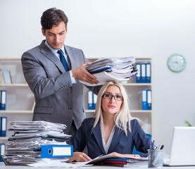 Canvas Print - Boss bringing additional work to his assistant secretary