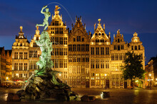Antwerp Famous Brabo Statue And Fountain On Grote Markt Square Illuminated At Night And Old Houses. Antwerp, Belgium