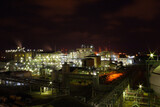 Fototapeta Las - The light of a petrochemical factory that is normally produced on nights with full stars.