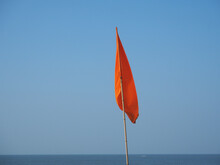 Red Warning Flag At The Beach. Sign Prohibiting Swimming In This Place