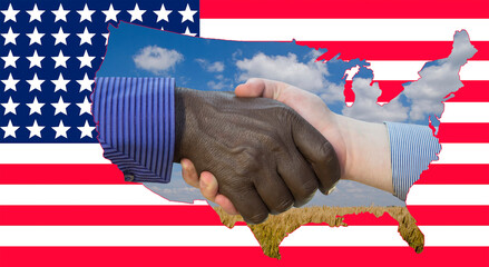 Close up photo of a handshake between afroamerican and european hands. Handshake in front of US flag. On the flag are the contours of the US mills and the wheat field.