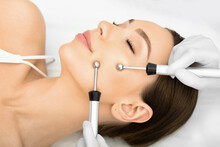 Woman Getting Microcurrent Procedure Facelift. Beautician Doing Anti-aging, To Perform Facial Tightening And Toning.