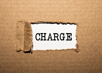 The text CHARGE. behind torn brown paper