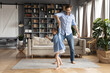 © fizkes - Happy father dancing with adorable little daughter wearing dress, holding hands, moving to favorite music in living room, family having fun, smiling dad and cute girl enjoying leisure time together