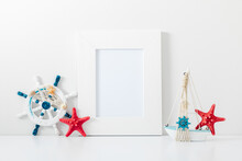 Summer Composition. Travel Concept. White Frame Mockup In Interior With Sea Elements On White Wall Background. Template Frame For Text. Poster Mockup.