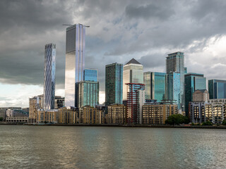 Wall Mural - Tall buildings accros the river Thames in the city area of London, Canary Wharf financial district of England