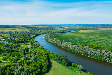 Wall Mural - Beautiful green summer nature landscape with river and meadows, aerial view drone shot.