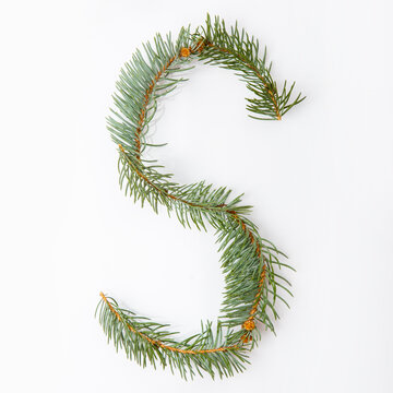 Letter S from green christmas-tree isolated on white. Natural Letter S, stylish alphabet. Handmade abc. Text from spruce. Christmas winter Sale. X-mas numbers. Winter font. 