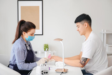 Sticker - Manicure master working with male client in beauty salon