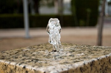 Sticker - Closeup shot of the water fountain on blurred background