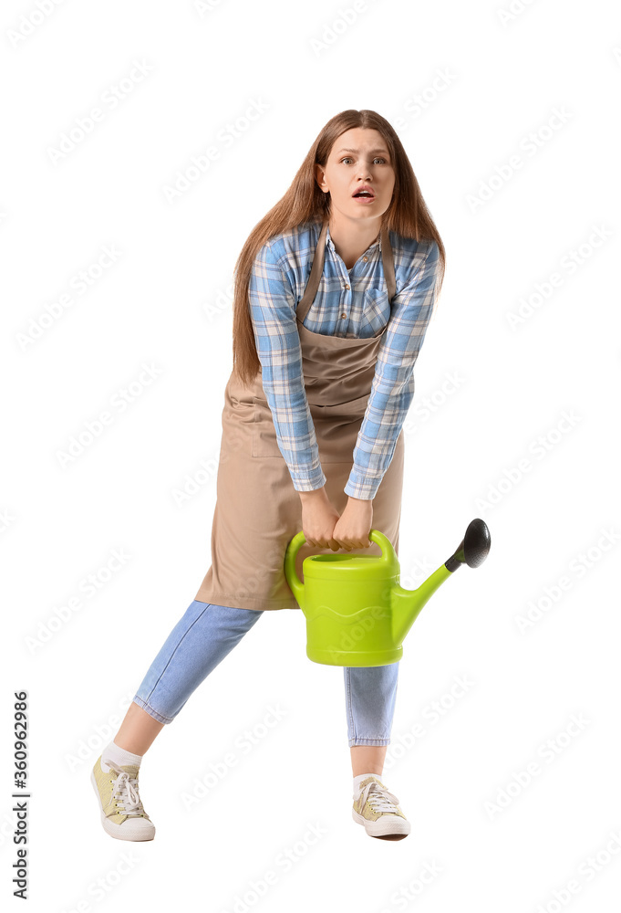 Young woman with heavy watering can on white background