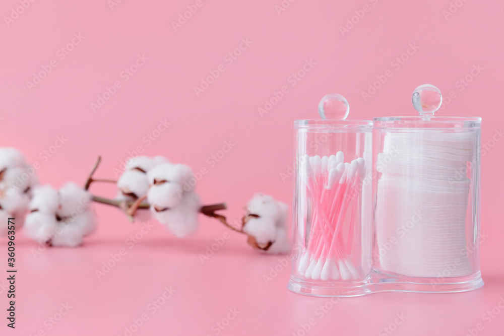 Cotton pads and swabs on color background