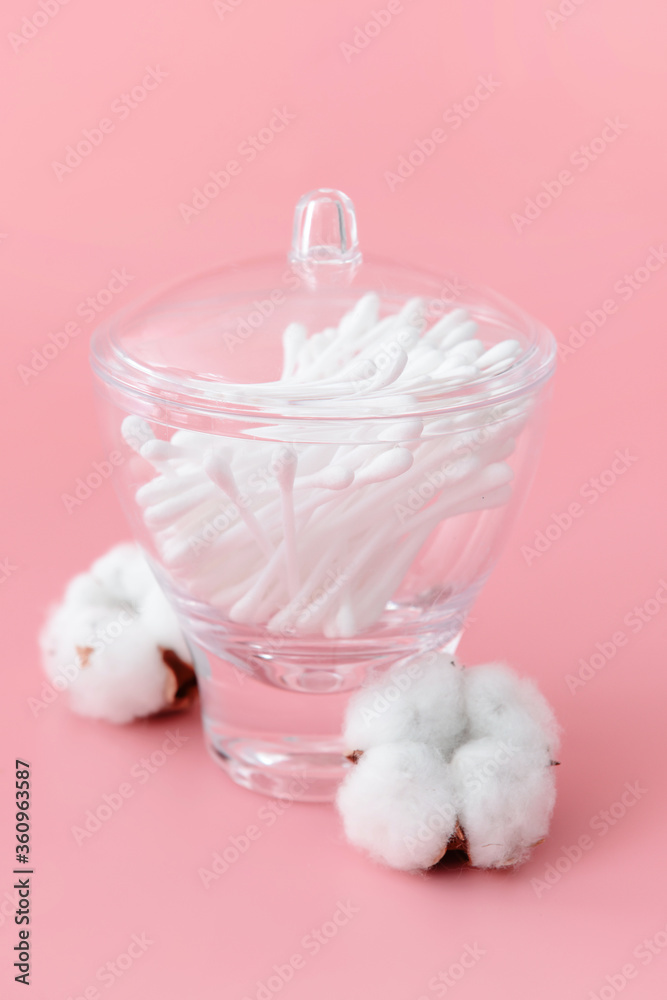 Cotton cosmetic swabs on color background