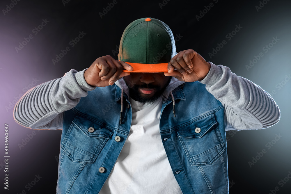 Male African-American hip-hop dancer on dark background