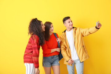 Sticker - Young students taking selfie on color background